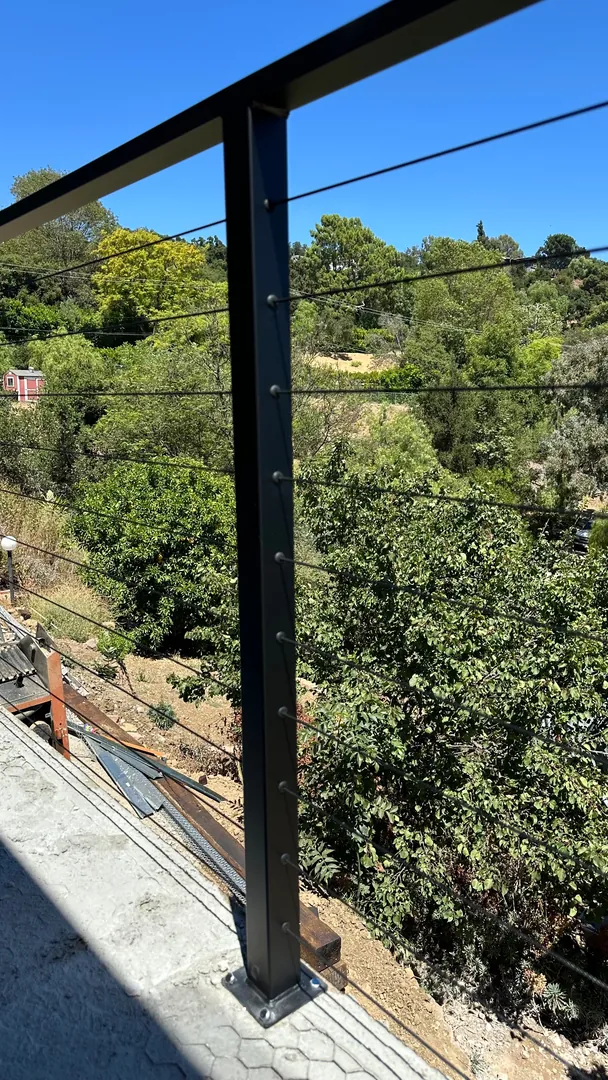 Cable railing overlooking a green valley